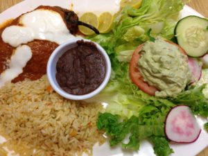 Chili Relleno Con Carne: Stuffer pasilla pepper with homemade stuffing of pork, potato, carrots and topped with homemade salsa.