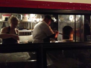 Josh and Sarah working in the kitchen of the bus