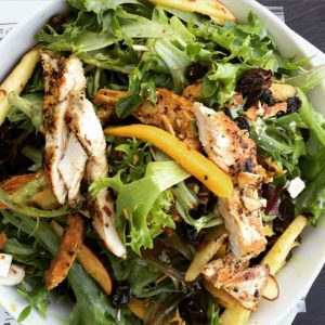 Curry Chicken Salad: grilled chicken, mixed greens, mango, apples, raisins, almonds and curry vinaigrette