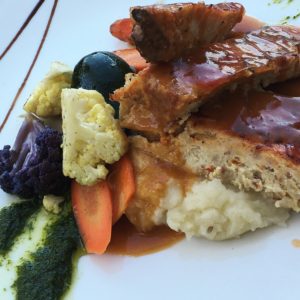 Chicken Pancetta Meatloaf: Ground chicken and pancetta with onions, sundried tomatoes with a savory tomato glaze With Mashed potatoes and vegetables.