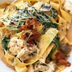 Chicken Pappardelle: Tossed with mushrooms, spinach and a spicy cream sauce.